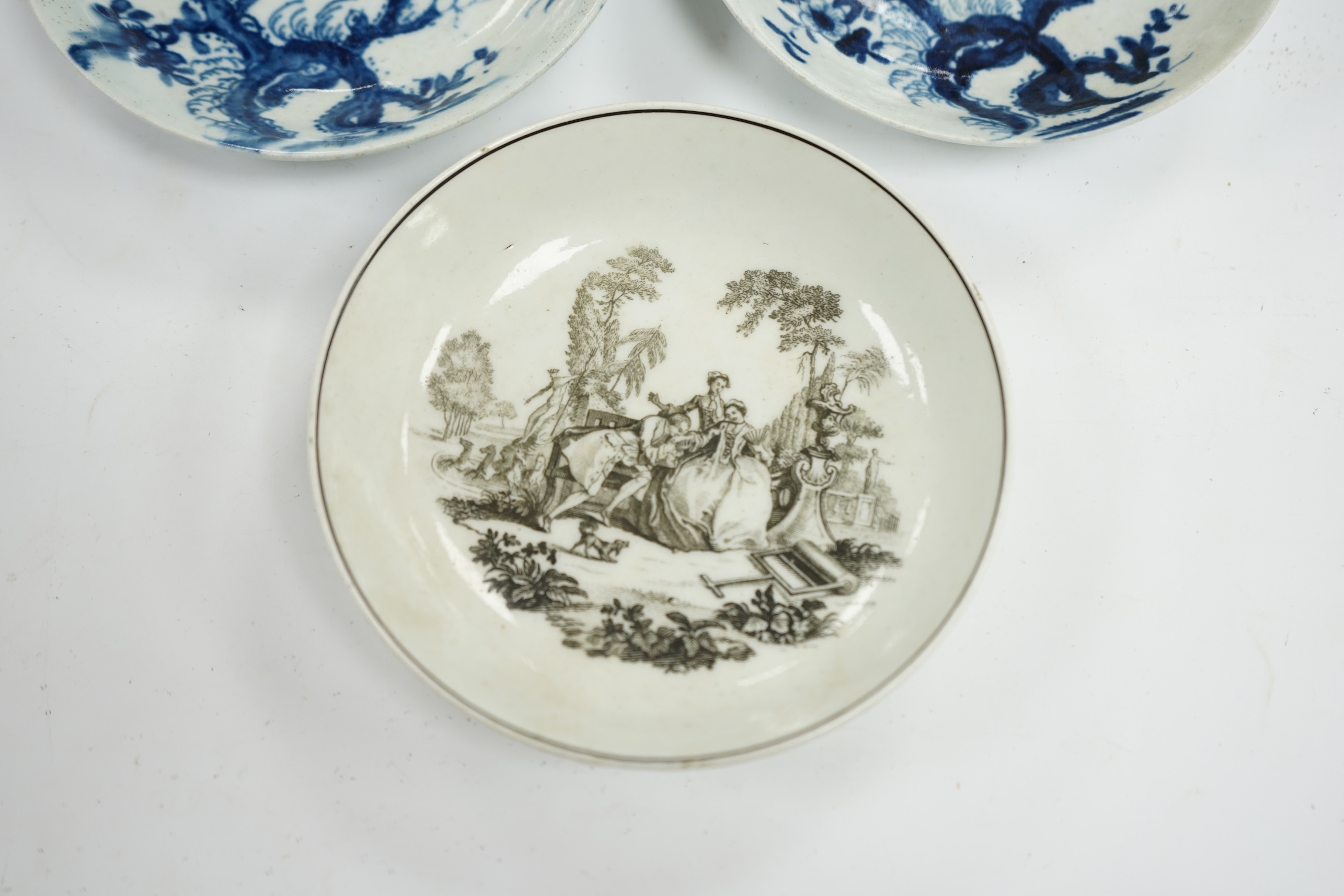 An 18th century Worcester saucer printed by Hancock and a pair of 18th century Liverpool prunus root saucers, Hancock saucer 12cm diameter. Condition - fair to good